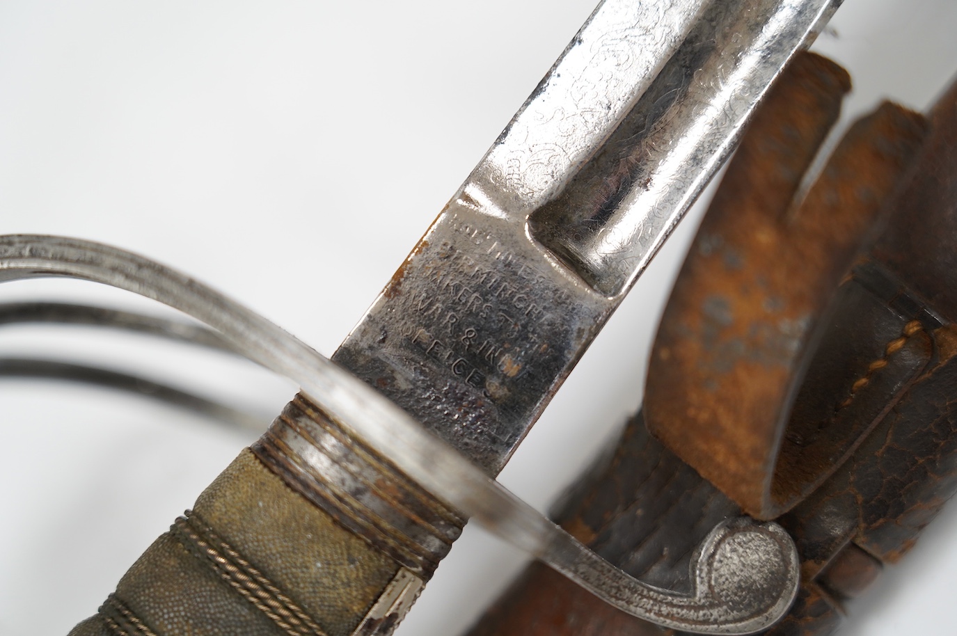 A George V Royal Artillery sword, regulation blade and hilt, in its leather scabbard, blade 90cm. Condition - poor, heavily pitted